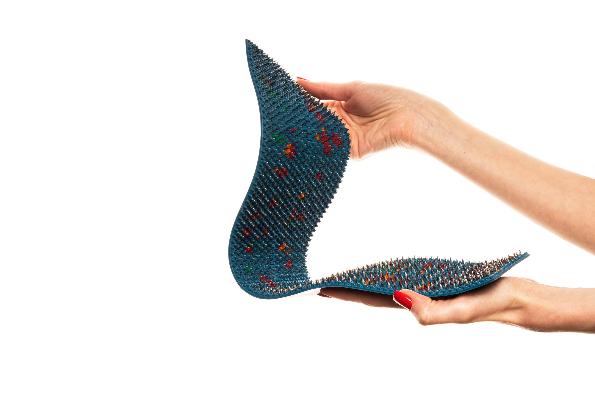 hand holding embroidered patch with geometric motif