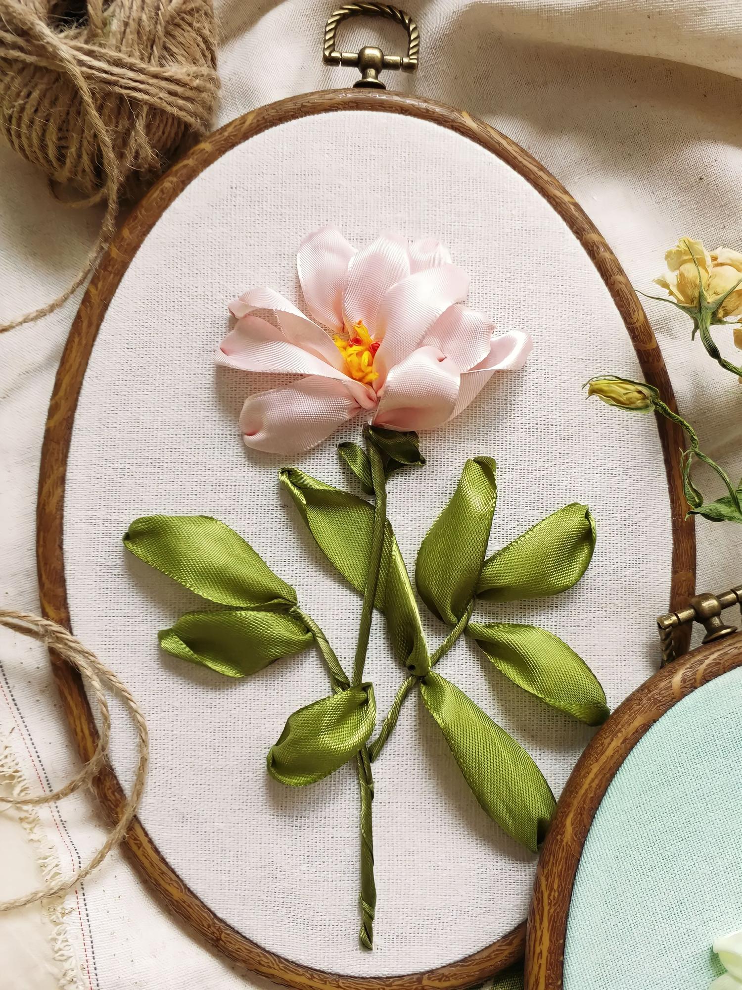 close-up of hand embroidery hoop with floral pattern
