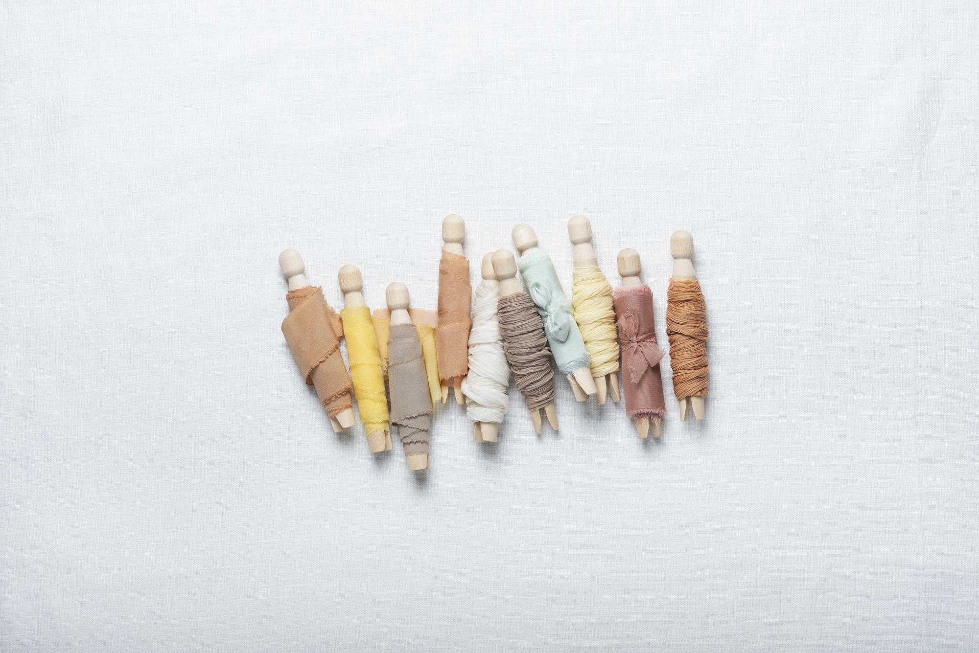 flatlay of thread spools and sketches